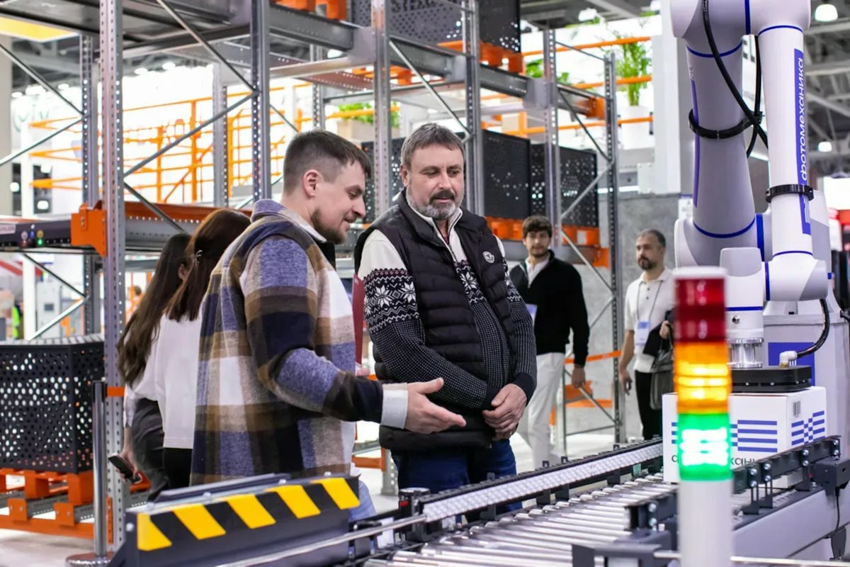 A team watching an automated conveyor line run