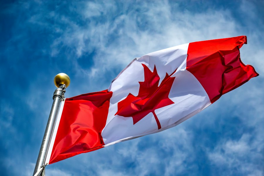 The Canadian flag against a blue sky