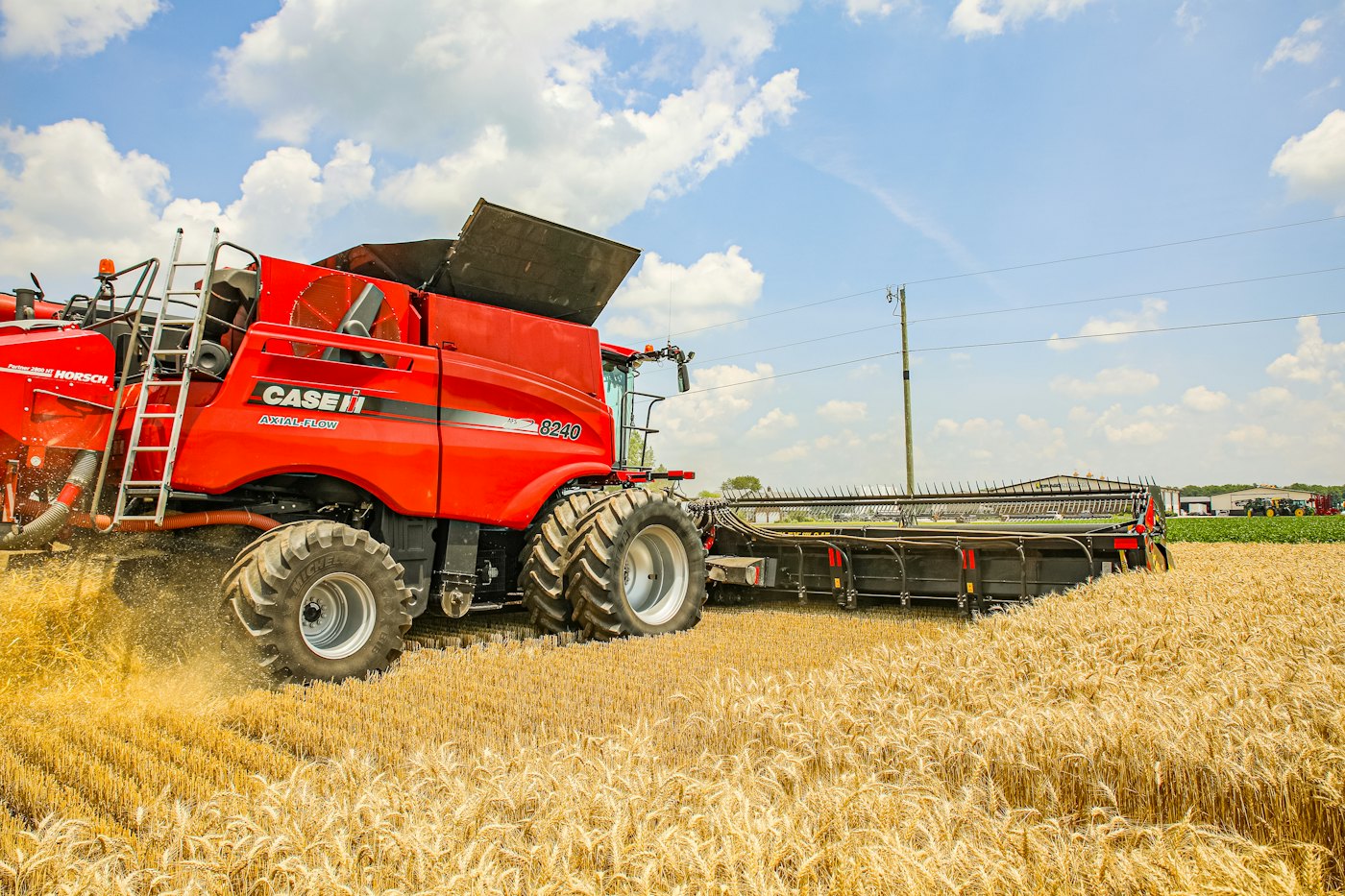A red combine harvesting a wheat field